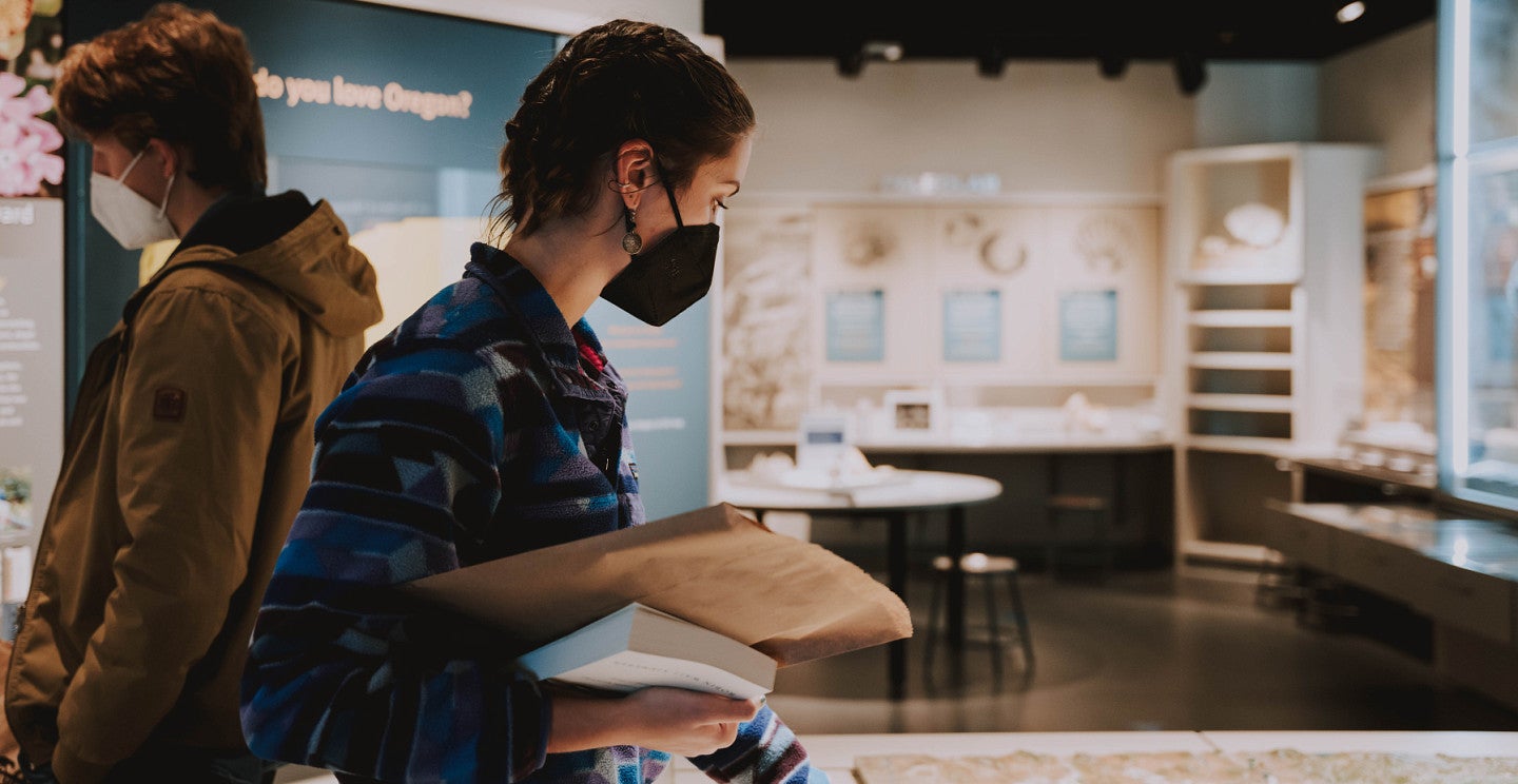 two students looking at museum exhibits