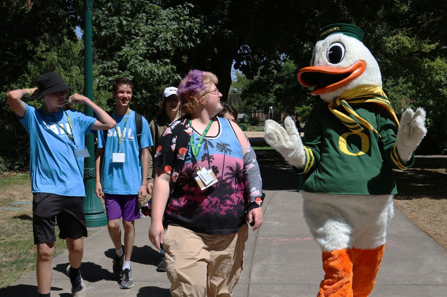 SAIL students walk alongside Duck mascot