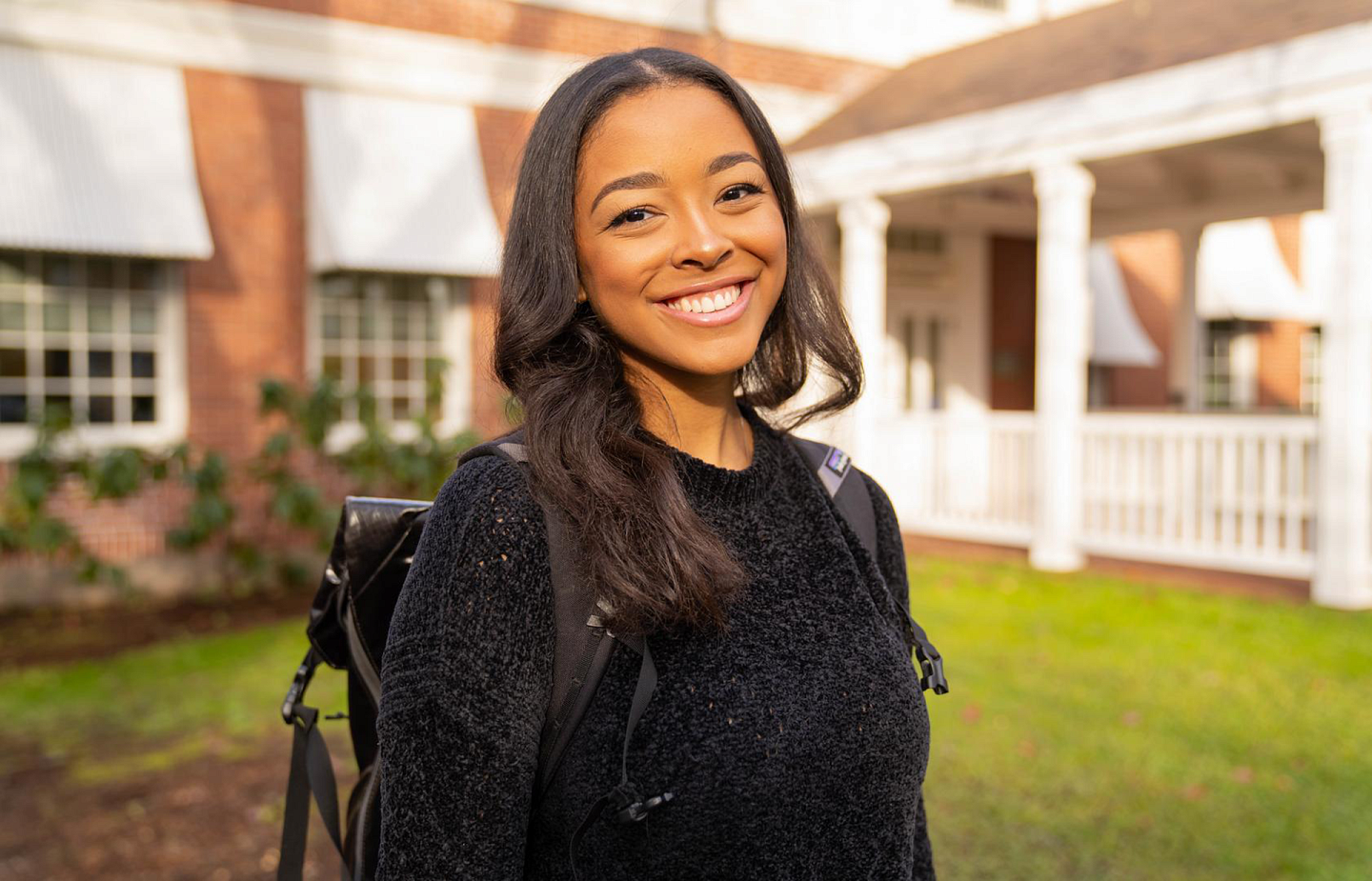 student posing outside smiling expression