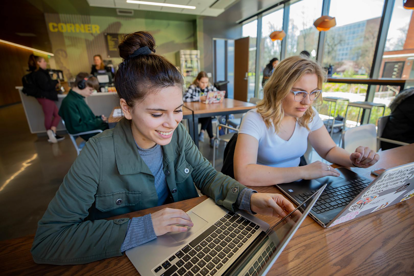 students on laptop in cafe