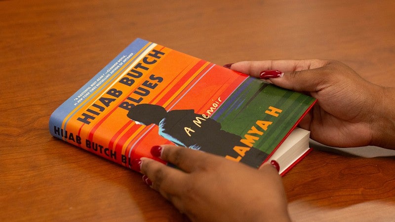 Photo of "Hijab Butch Blues" book cover lying on a table