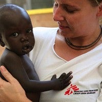 Photo of doctor holding baby.