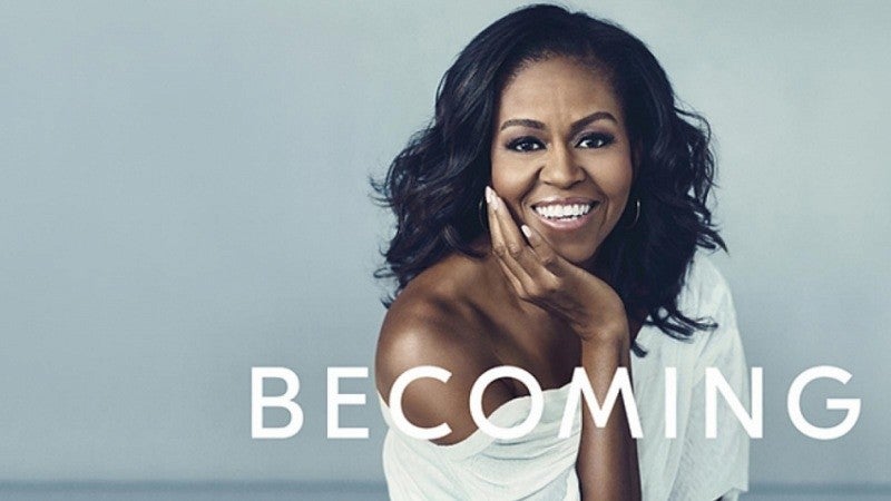 Photo of Michelle Obama with word "BECOMING" in white text
